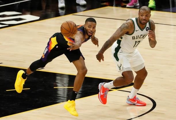 Mikal Bridges of the Phoenix Suns blocks a pass against P.J. Tucker of the Milwaukee Bucks during the first quarter in Game One of the NBA Finals at...