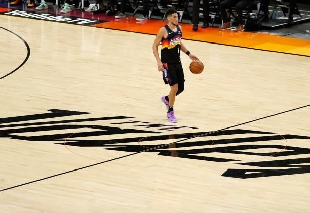Devin Booker of the Phoenix Suns brings the ball up court against the Milwaukee Bucks during the first quarter in Game One of the NBA Finals at...