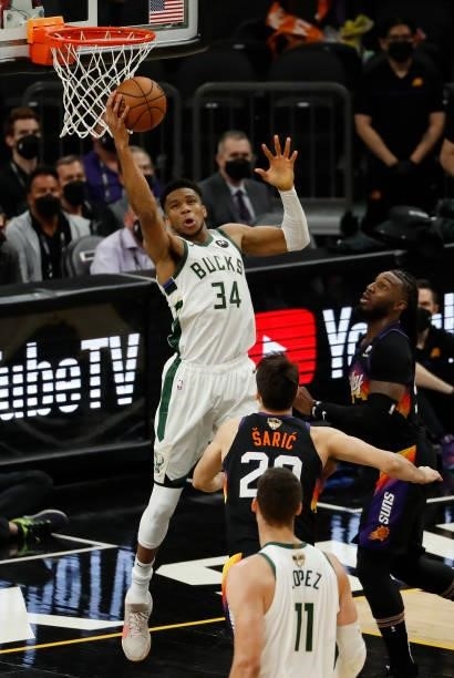 Giannis Antetokounmpo of the Milwaukee Bucks goes up for a shot against Dario Saric of the Phoenix Suns during the first quarter in Game One of the...