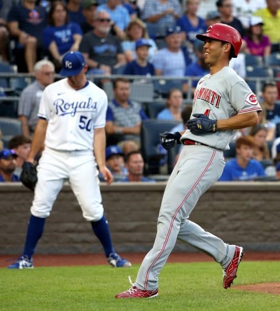 Shogo Akiyama of the Cincinnati Reds smiles after crossing home plate to score during the 3rd inning of the game against the Kansas City Royals at...