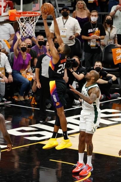 Mikal Bridges of the Phoenix Suns goes up for a shot against P.J. Tucker of the Milwaukee Bucks during the first half in Game One of the NBA Finals...