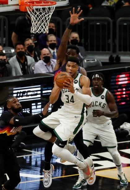 Giannis Antetokounmpo of the Milwaukee Bucks is pressured by the Phoenix Suns in Game One of the NBA Finals at Phoenix Suns Arena on July 06, 2021 in...