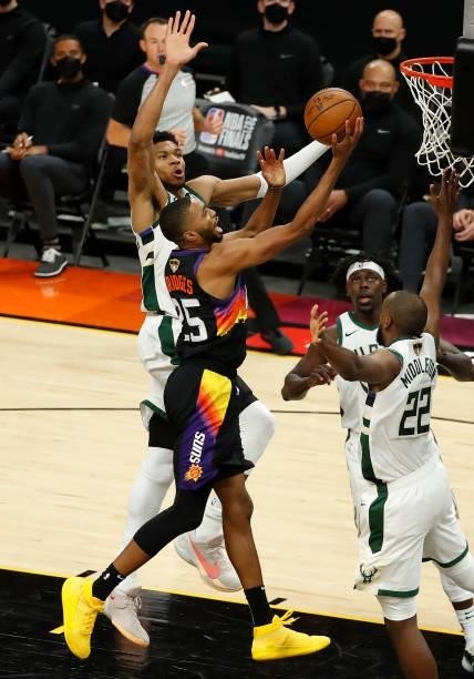 Mikal Bridges of the Phoenix Suns goes up for a shot against Giannis Antetokounmpo of the Milwaukee Bucks during the first half in Game One of the...