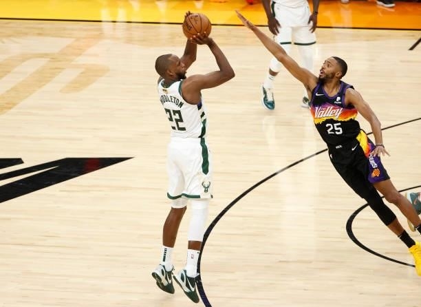 Khris Middleton of the Milwaukee Bucks shoots against Mikal Bridges of the Phoenix Suns during the first half in Game One of the NBA Finals at...