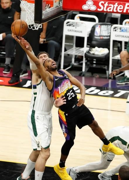 Mikal Bridges of the Phoenix Suns goes up for a shot against Brook Lopez of the Milwaukee Bucks during the first half in Game One of the NBA Finals...