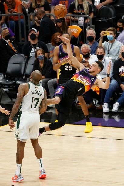 Tucker of the Milwaukee Bucks fouls Devin Booker of the Phoenix Suns during the first half in Game One of the NBA Finals at Phoenix Suns Arena on...