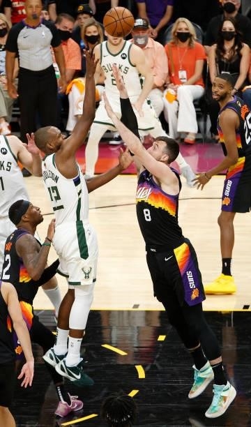 Khris Middleton of the Milwaukee Bucks goes up for a shot against Frank Kaminsky of the Phoenix Suns during the first half in Game One of the NBA...