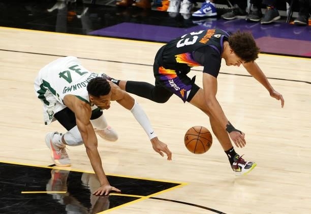 Giannis Antetokounmpo of the Milwaukee Bucks chases loose ball against Cameron Johnson of the Phoenix Suns during the second half in Game One of the...