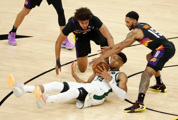 Giannis Antetokounmpo of the Milwaukee Bucks looses the ball against Cameron Payne of the Phoenix Suns during the second half in Game One of the NBA...