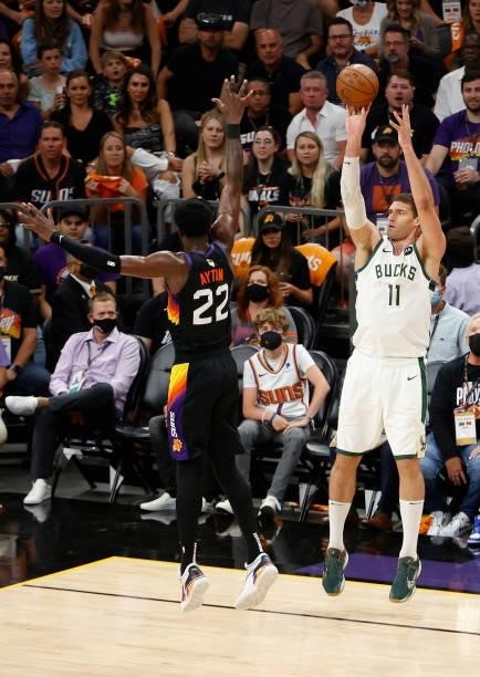 Brook Lopez of the Milwaukee Bucks shoots over Deandre Ayton of the Phoenix Suns during the second half in Game One of the NBA Finals at Phoenix Suns...
