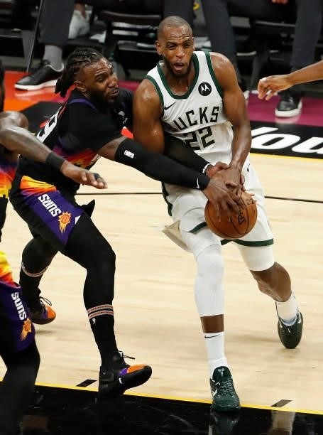 Jae Crowder of the Phoenix Suns and Khris Middleton of the Milwaukee Bucks fight for possession during the second half in Game One of the NBA Finals...