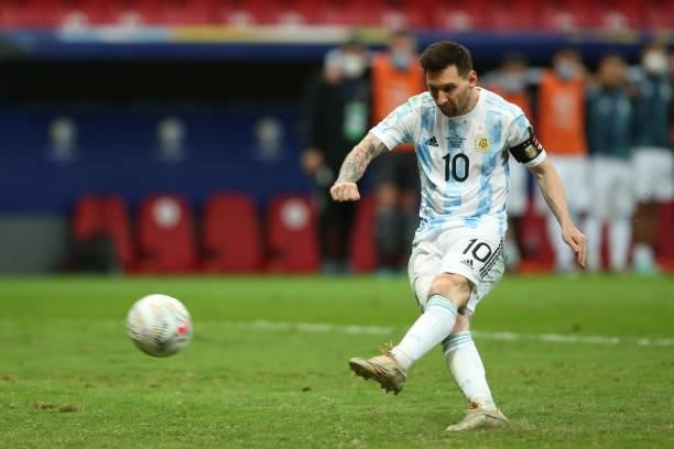 Lionel Messi of Argentina scores his penalty kick during a shootout after a semi-final match of Copa America Brazil 2021 between Argentina and...