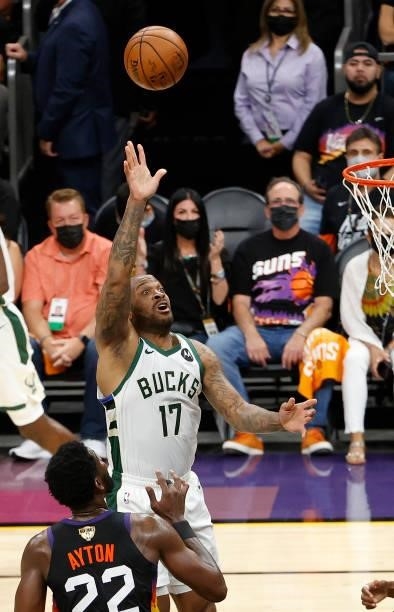 Tucker of the Milwaukee Bucks shoots over Deandre Ayton of the Phoenix Suns during the first half in Game One of the NBA Finals at Phoenix Suns Arena...
