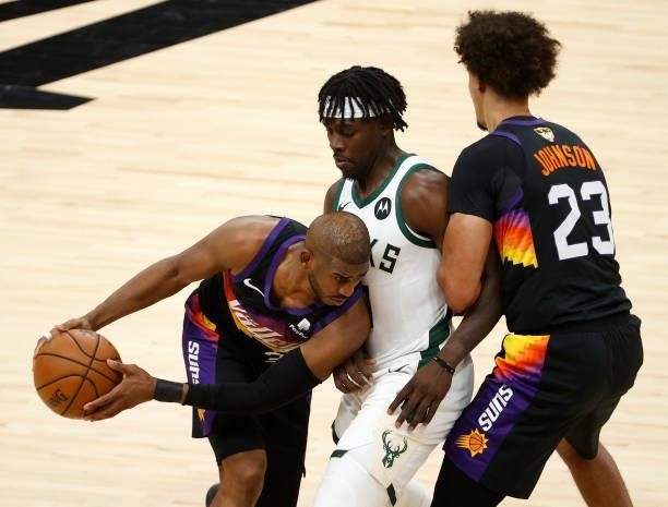 Chris Paul of the Phoenix Suns is pressured by Jrue Holiday of the Milwaukee Bucks during the second half in Game One of the NBA Finals at Phoenix...