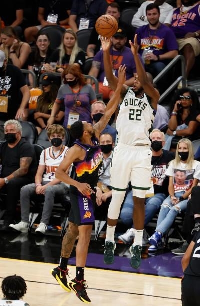 Khris Middleton of the Milwaukee Bucks shoots over Cameron Payne of the Phoenix Suns during the second half in Game One of the NBA Finals at Phoenix...