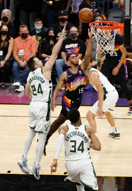 Cameron Payne of the Phoenix Suns goes up for a shot against Pat Connaughton of the Milwaukee Bucks during the second half in Game One of the NBA...