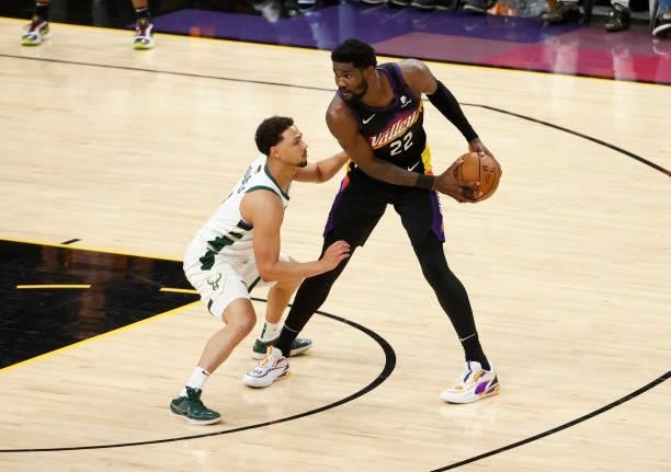 Deandre Ayton of the Phoenix Suns is defended by Jeff Teague of the Milwaukee Bucks during the first half in Game One of the NBA Finals at Phoenix...