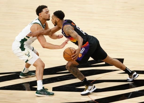Cameron Payne of the Phoenix Suns drives against Jeff Teague of the Milwaukee Bucks during the first half in Game One of the NBA Finals at Phoenix...