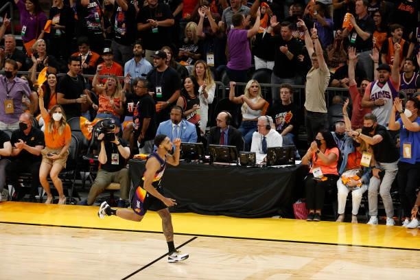 Fans cheer after a Cameron Payne of the Phoenix Suns three point basket against the Milwaukee Bucks during the first half in Game One of the NBA...