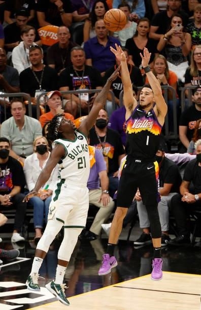Devin Booker of the Phoenix Suns shoots against Jrue Holiday of the Milwaukee Bucks during the first half in Game One of the NBA Finals at Phoenix...