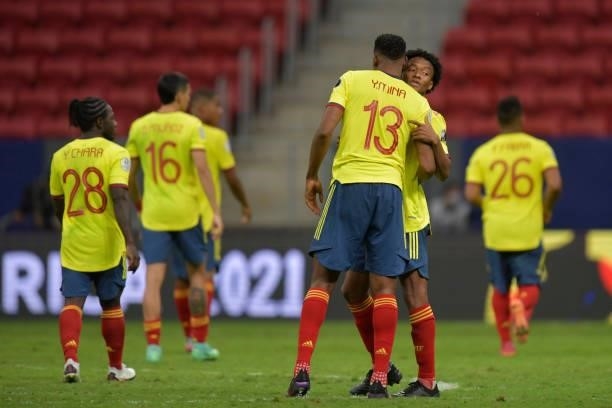 Yerry Mina of Colombia greets teammate Juan Cuadrado after losing a penalty shootout after a semi-final match of Copa America Brazil 2021 between...