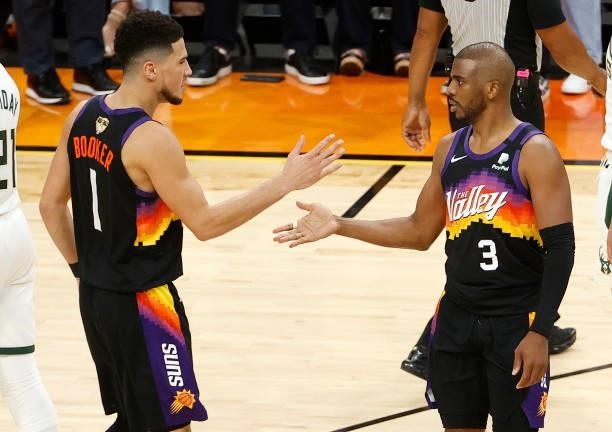Devin Booker and Chris Paul of the Phoenix Suns celebrate during the second half in Game One of the NBA Finals against the Milwaukee Bucks at Phoenix...