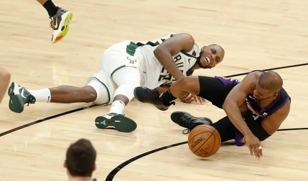 Khris Middleton of the Milwaukee Bucks and Chris Paul of the Phoenix Suns go after a loose ball during the second half in Game One of the NBA Finals...