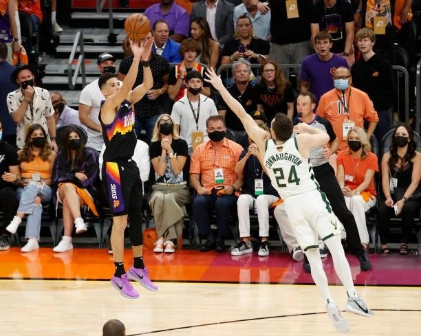 Devin Booker of the Phoenix Suns shoots against Pat Connaughton of the Milwaukee Bucks during the second half in Game One of the NBA Finals at...