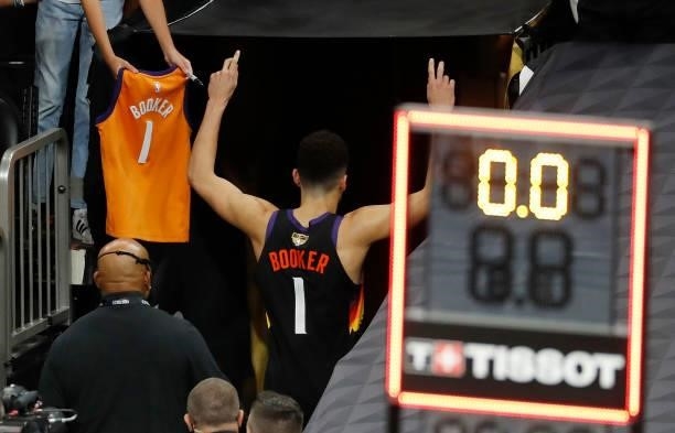 Devin Booker of the Phoenix Suns leaves the court after the team's win against the Milwaukee Bucks following Game One of the NBA Finals at Phoenix...