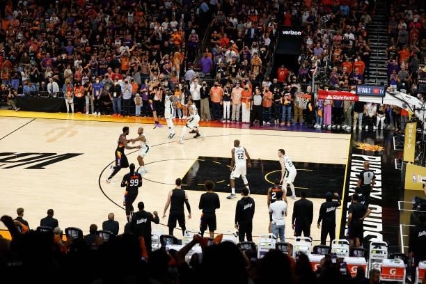 Devin Booker of the Phoenix Suns shoots a three point basket against the Milwaukee Bucks during the second half in Game One of the NBA Finals at...