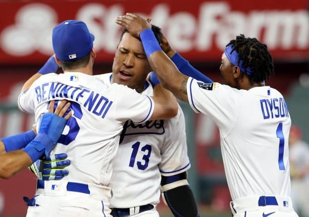 Andrew Benintendi and Jarrod Dyson rush to congratulate Salvador Perez of the Kansas City Royals after Perez hit the game-winning walk-off single to...