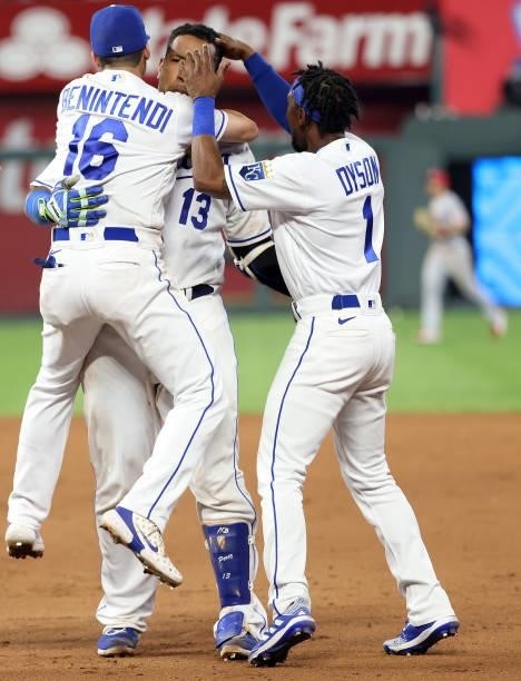 Andrew Benintendi and Jarrod Dyson rush to congratulate Salvador Perez of the Kansas City Royals after Perez hit the game-winning walk-off single to...