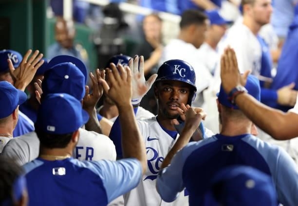 Michael A. Taylor of the Kansas City Royals is congratulated by teammates in the dugout after hitting a home run during the 5th inning of the game...