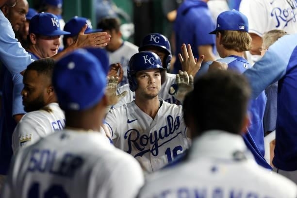 Andrew Benintendi of the Kansas City Royals is congratulated by teammates in the dugout after hitting a home run during the 8th inning of the game...