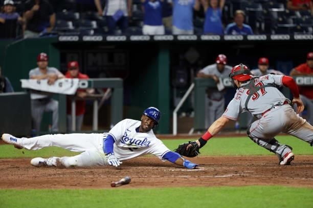 Michael A. Taylor of the Kansas City Royals slides safely past catcher Tyler Stephenson of the Cincinnati Reds to score on a single by Nicky Lopez...