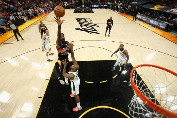 Deandre Ayton of the Phoenix Suns puts up a shot over P.J. Tucker of the Milwaukee Bucks during the first half of game one of the NBA Finals at...