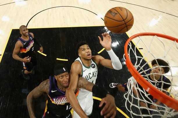 Giannis Antetokounmpo of the Milwaukee Bucks puts up a shot over Torrey Craig of the Phoenix Suns during the second half of game one of the NBA...