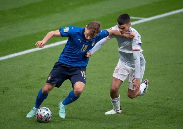 Nicolò Barella of Italy and Pedri of Spain in action during the UEFA Euro 2020 Championship Semi-final match between Italy and Spain at Wembley...