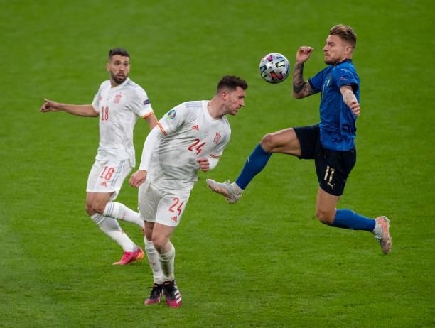 Aymeric Laporte and Jordi Alba of Spain in action with Domenico Berardi of Italy during the UEFA Euro 2020 Championship Semi-final match between...
