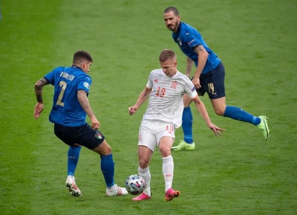 Dani Olmo of Spain in action with Giovanni Di Lorenzo and Leonardo Bonucci of Italy during the UEFA Euro 2020 Championship Semi-final match between...