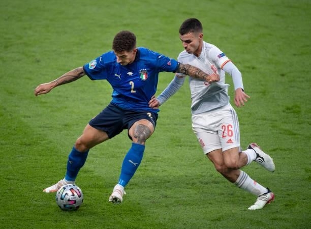 Giovanni Di Lorenzo of Italy and Pedri of Spain in action during the UEFA Euro 2020 Championship Semi-final match between Italy and Spain at Wembley...