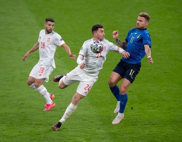 Aymeric Laporte and Jordi Alba of Spain in action with Domenico Berardi of Italy during the UEFA Euro 2020 Championship Semi-final match between...