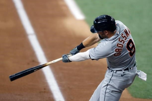 Robbie Grossman of the Detroit Tigers hits a RBI single against the Texas Rangers in the top of the first inning at Globe Life Field on July 07, 2021...
