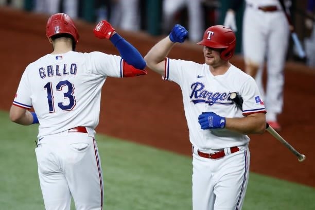 Joey Gallo of the Texas Rangers celebrates with John Hicks of the Texas Rangers after hitting a solo home run in the bottom of the fourth inning...