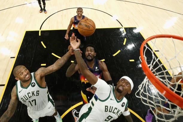 Tucker and Bobby Portis of the Milwaukee Bucks reach for a rebound during the game one of the NBA Finals at Phoenix Suns Arena on July 06, 2021 in...