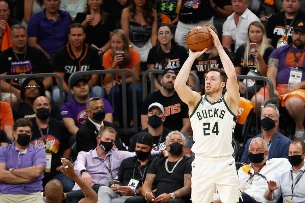 Pat Connaughton of the Milwaukee Bucks shoots against the Phoenix Suns during game one of the NBA Finals at Phoenix Suns Arena on July 06, 2021 in...