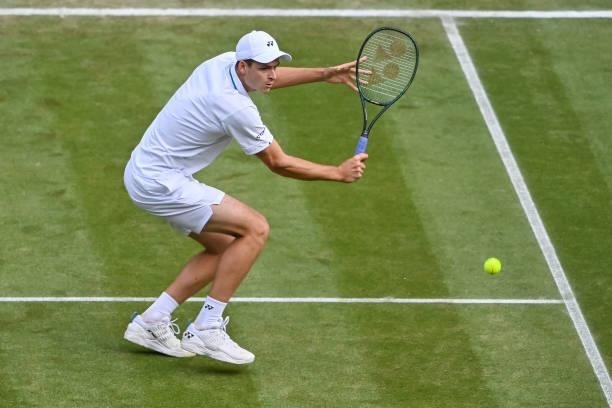 Hubert Hurkacz of Poland hits a backhand against Roger Federer of Switzerland in the quarter finals of the gentlemen's singles during Day Nine of The...