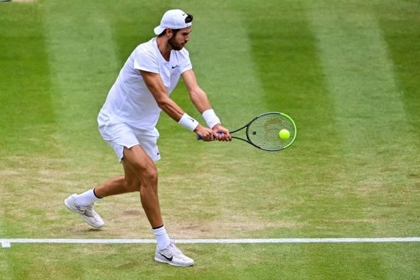 Karen Khachanov of Russia hits a backhand against Dennis Shapovalov of Canada in the quarter finals of the gentlemen's singles during Day Nine of The...