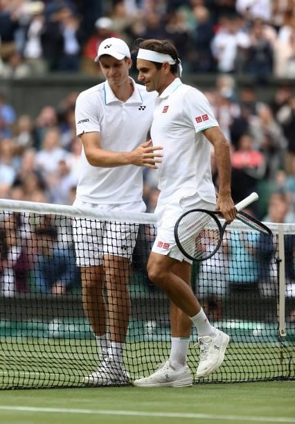 Hubert Hurkacz of Poland shakes hands with Roger Federer of Switzerland after winning their men's Singles Quarter Final match on Day Nine of The...