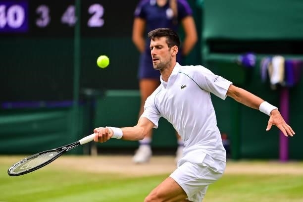Novak Djokovic of Serbia hits a forehand against Marton Fucsovics of Hungary in the quarter finals of the gentlemen's singles during Day Nine of The...